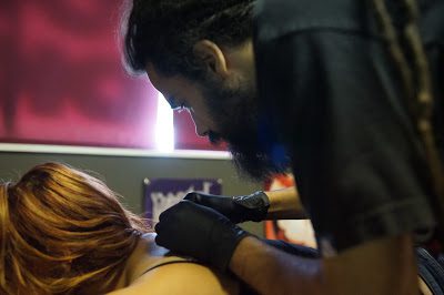 A Man Making Tattoo On A Woman