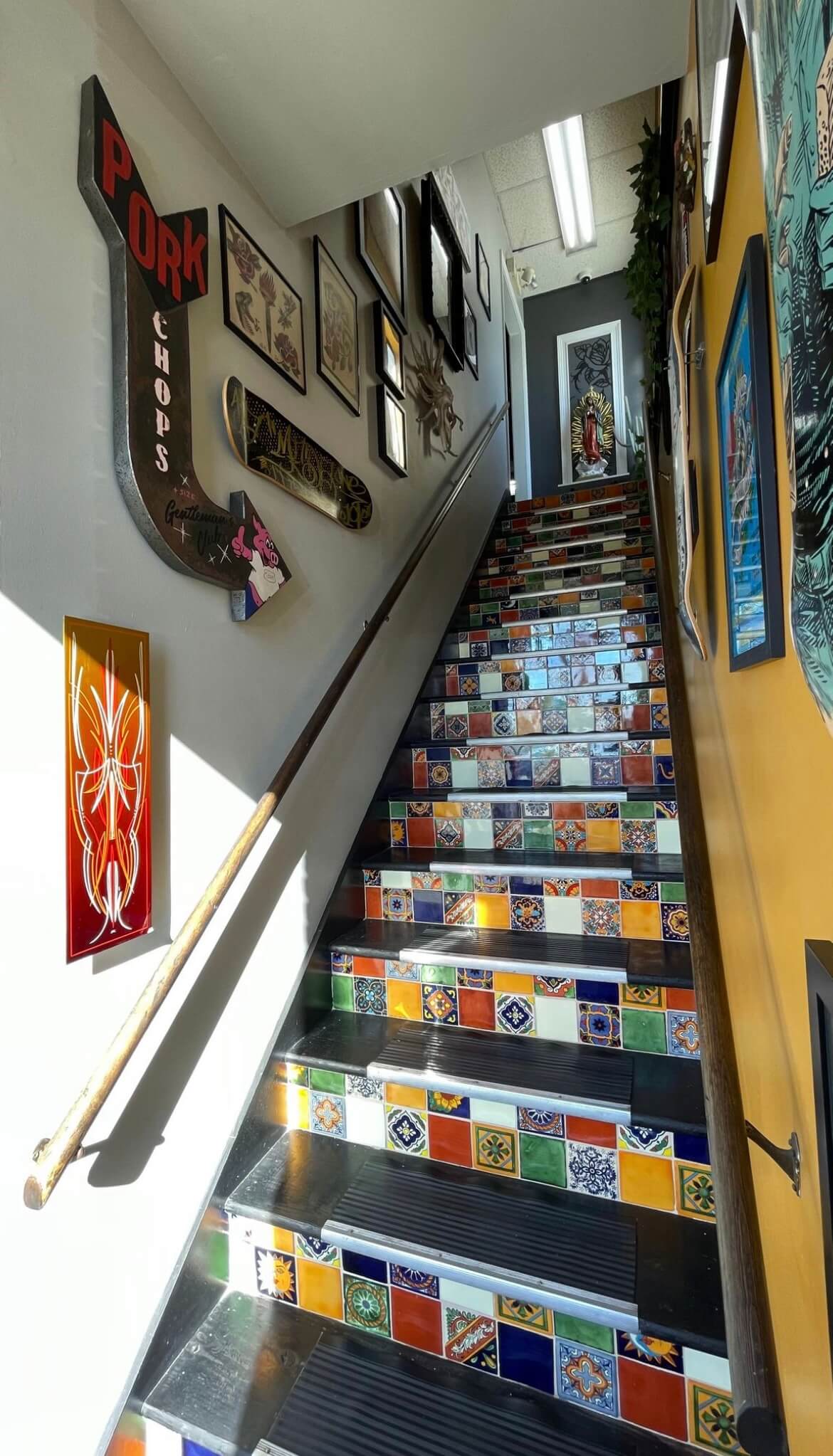 A staircase with multicolored tile accents